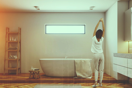 Woman in a white bathroom interior with a white tub, a double sink and a long mirror above it. Morining. 3d rendering mock up toned image double exposureの写真素材