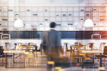 Bar interior with white walls, a wooden floor, square table with chairs near them and shelves with bottles near the wall. An African American man 3d rendering toned image double exposure blurredの写真素材