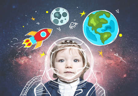 Adorable little boy in suit dreaming of becoming astronaut. Open space background, rocket, Earth and Moon doodles and a space travel uniform. Double exposure. Elements of this image furnished by NASAの写真素材