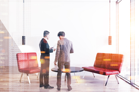 Two businessmen facing each other talking in a red sofa office with a round coffee table. Concept of business. 3d rendering mock up toned image double exposureの写真素材