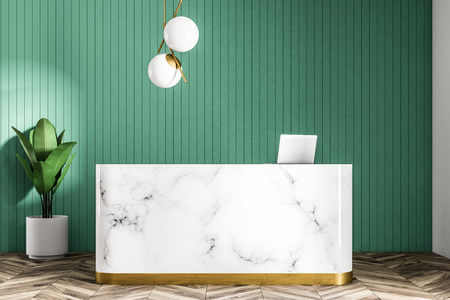 Marble reception with a computer on it standing in a modern company office with green walls, a plant and a round ceiling lamp. 3d rendering mock upの写真素材