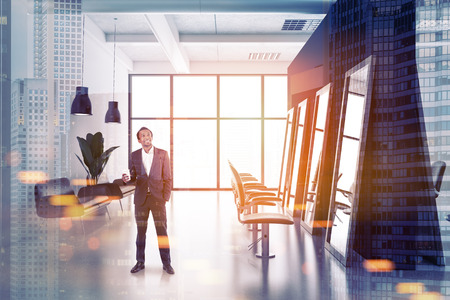 Smiling African American man in a modern barber shop interior with white and black walls, tall mirrors and comfortable beige chairs. A side view. 3d rendering toned image double exposureの写真素材