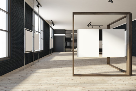 Black brick poster gallery with a wooden floor and loft windows. Vertical empty posters hanging on...