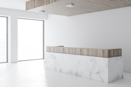 Marble and wooden reception desk standing in a modern office lobby with a white floor and walls and panoramic windows. 3d rendering mock upの写真素材