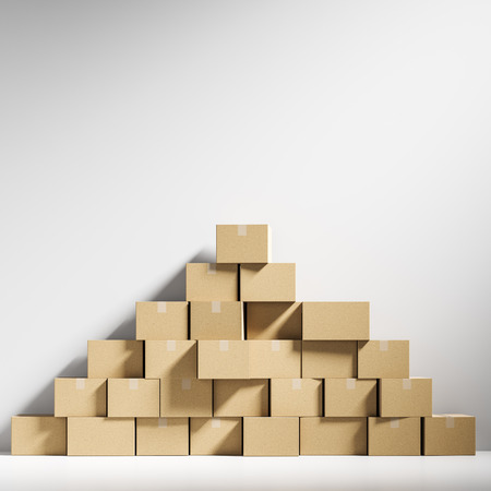 Pyramid made of closed cardboard boxes lying against a white wall background in an empty room. Concept of delivering goods, consumerism and overproduction. 3d rendering mock upの写真素材
