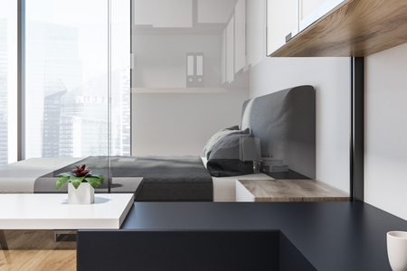 Luxury bedroom interior with white and glass walls, a wooden floor, a panoramic window with a cityscape and a double bed. Side view 3d rendering mock upの写真素材