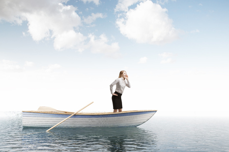 Lonely businesswoman standing in an oar boat in an open sea and crying for help.Concept of travelling, adventure and wrong business decisions. 3d rendering mock upの写真素材