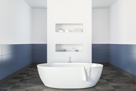 Modern bathroom interior with white and blue walls, a tiled floor, a white bathtub and shelves in the wall. 3d rendering mock upの写真素材
