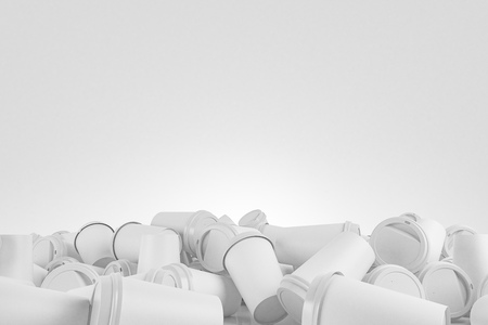 White coffee paper cups with white lids lying on the floor against a white background. Concept of addiction, office lifestyle and recycling. 3d rendering mock upの写真素材