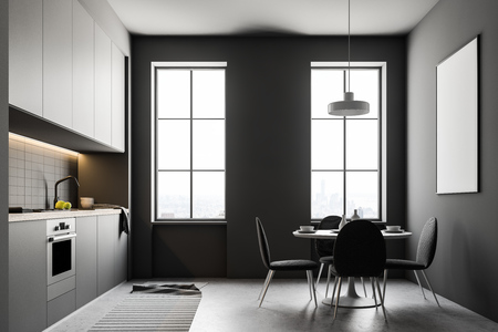 Modern kitchen interior with gray walls, large windows, a concrete floor and white countertops. A round table with chairs and a poster on the wall. 3d rendering mock upの写真素材