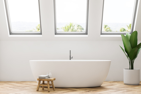 Luxury resort spa or villa bathroom interior with white walls, a wooden floor, a large white bathtub, and a potted plant. Relaxation and self care concept. 3d rendering mock upの写真素材