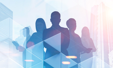 Silhouettes of diverse business team members standing together. Cityscape, communication and working as a team concept. Triangle tiles foreground Toned image double exposure copy spaceの写真素材
