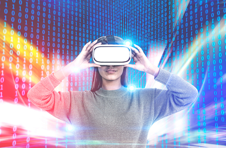 Attractive young woman wearing a sweater and vr glasses standing over a matrix like interface. Hi...