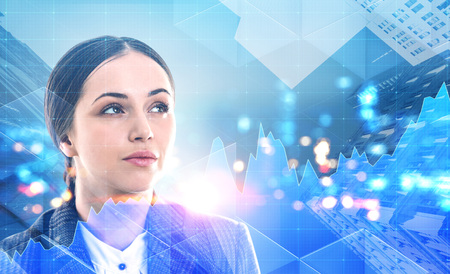 Smart european businesswoman looking up over a night cityscape background. Graphs foreground. Toned image double exposure copy spaceの写真素材