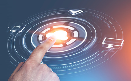 Hand of man using glowing cloud computing interface icons with hud over blue red background. Hi tech...