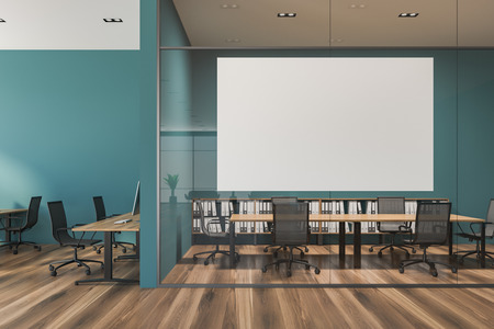 Interior of open plan office with green walls, a wooden floor, rows of wooden computer desks and...