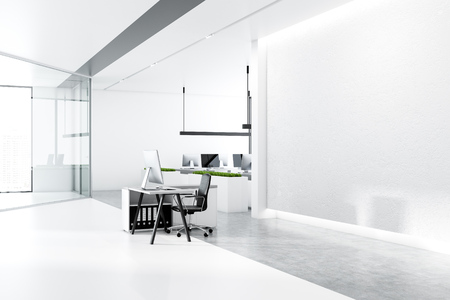 Minimalistic office interior with white walls, concrete floor with rows of white tables with black computer screens and panoramic windows. Side view of mock up wall and small desk. 3d renderingの写真素材