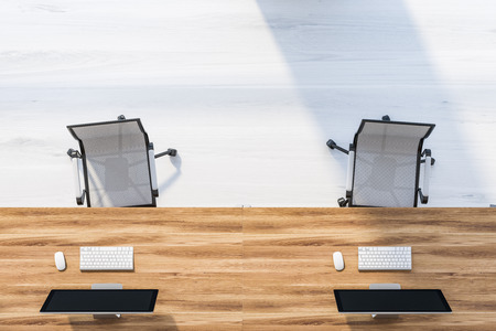Top view of wooden computer table with metal office chairs standing on gray wooden floor. Business lifestyle concept. 3d rendering mock upの写真素材