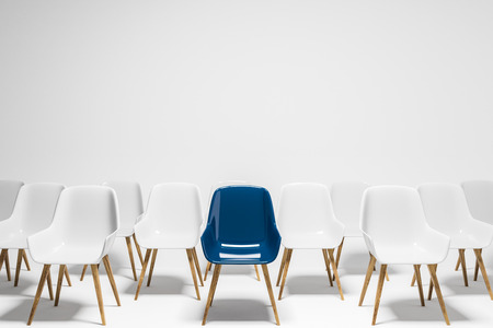 Rows of white chairs with a pink chair standing among them. Concept of choice and being unique. 3d rendering copy spaceの写真素材