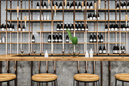 Close up of stylish bar with gray brick walls, wooden table and stools. Bottles on shelves. Small business concept. 3d renderingの写真素材
