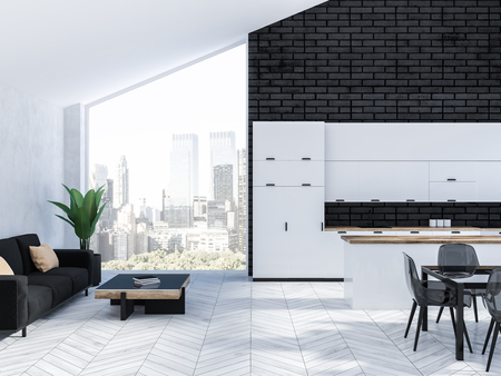 Stylish kitchen interior with black brick walls, white wooden floor, white countertops and black table with transparent chairs. Black sofa near the wall 3d renderingの写真素材