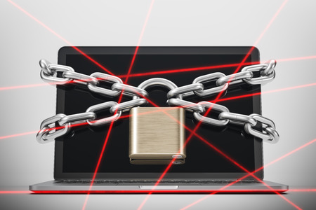 Laptop standing on white desk with big chains and padlock over the screen. Laser rays. Digital security concept. 3d renderingの写真素材