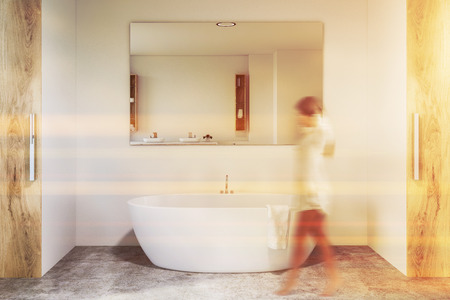 Woman Walking In Modern Bathroom Interior With White Walls Woman Walking In Modern Bathroom
