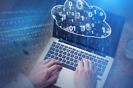 Top view of businessman hands typing on laptop keyboard with cloud computer hologram above it....