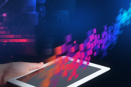 Hand of man holding tablet computer over dark blue background with double exposure of red flow of...