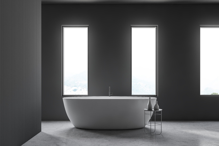 Interior of modern bathroom with gray walls, stone floor, loft windows and white bathtub standing near the chair with shampoo. 3d renderingの写真素材