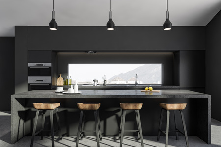 Interior of modern kitchen with gray walls, concrete floor, gray bar with wooden stools and gray...