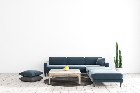 Minimalistic living room interior with white walls, wooden floor, dark blue sofa standing near wooden coffee table, round rug and cushions on the floor. 3d renderingの写真素材