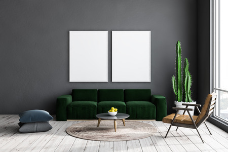 Gray living room interior with light wooden floor, green sofa and leather armchair near round coffee...