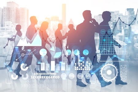 Silhouettes of business people working together and communicating over cityscape background with double exposure of business infographics interface. Toned imageの写真素材