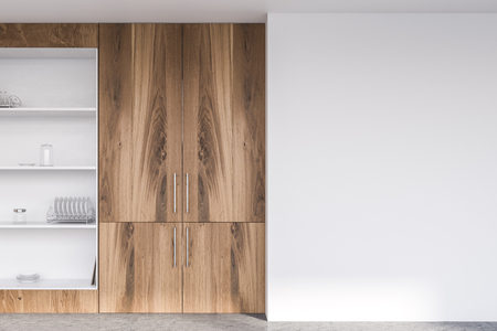 Big wooden and white cupboard with dishes standing in modern kitchen with white walls and concrete floor. 3d rendering mock upの写真素材