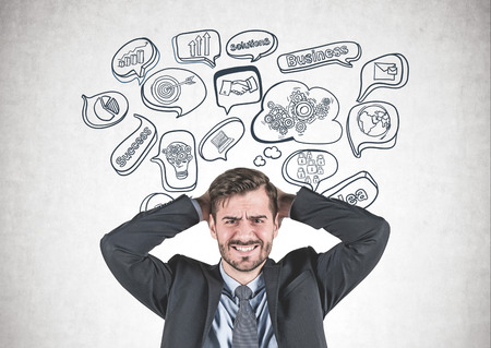 Portrait of stressed young businessman in suit standing with clenched teeth and painful expression...