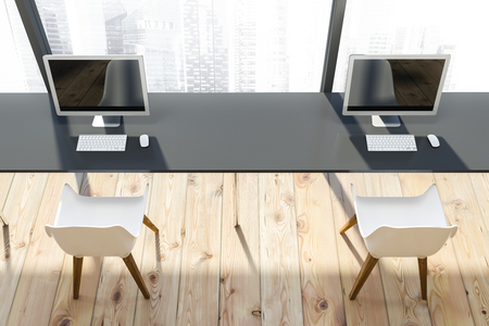 Top view of gray computer table with white chairs standing in modern office with panoramic window and wooden floor. 3d renderingの写真素材
