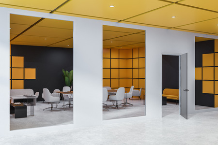 Side view of office meeting room with black and yellow walls, concrete floor and long wooden table with white chairs as seen from the lobby. 3d renderingの写真素材