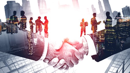 Double exposure with business handshaking on New York skyline. Red toned image. Concept of international business and logistics.の写真素材