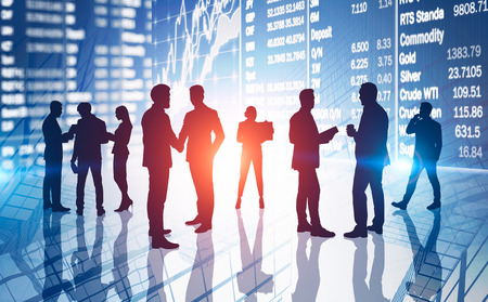 Silhouettes of business people communicating over abstract stock market background with double...