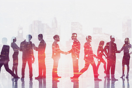 Business people shaking hands, talking and walking in modern city with double exposure of network...