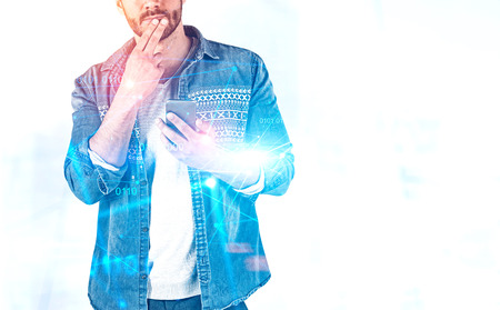 Unrecognizable pensive casual man with smartphone over white background with double exposure of...