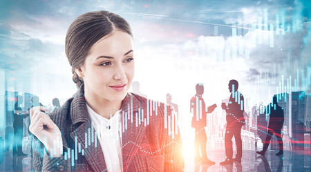 Thinking young businesswoman portrait over abstract city background with double exposure of communicating business people and graphs. Concept of teamwork. Toned imageの写真素材