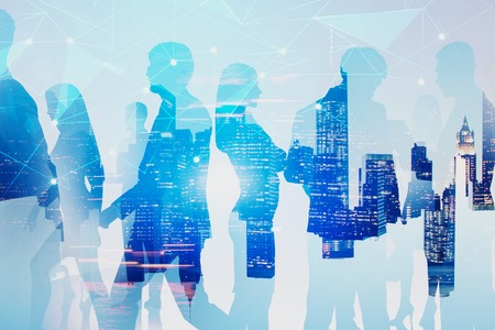 Silhouettes of business people walking, communicating and discussing documents over night cityscape...