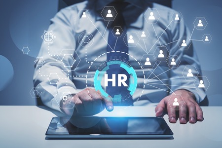 Man in shirt and tie using tablet computer at table with double exposure of HR and social connection HUD interface. Concept of recruitment and hi tech. Toned imageの写真素材