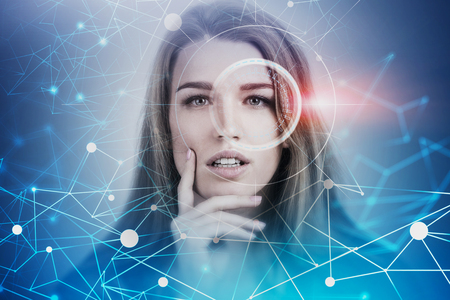 Portrait of beautiful thinking blonde woman with HUD interface and network hologram. Concept of artificial intelligence and deep learning. Toned image double exposureの写真素材