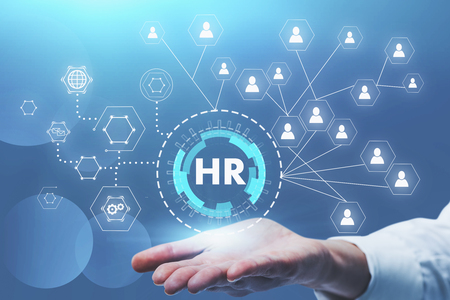 Businessman hand holding HR and social connection hologram. Concept of recruitment and hi tech. Toned imageの写真素材