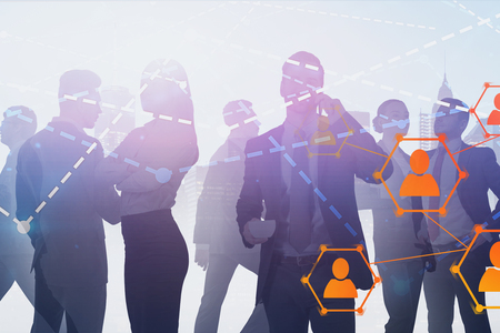 Silhouettes of business people communicating over cityscape background with double exposure of...