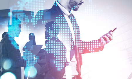 Side view of young business leader and members of his team in city with double exposure of digital world map. Concept of leadership and modern technology. Toned imageの写真素材