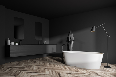 Modern bathroom interior with gray walls, wooden floor, white bathtub with floor lamp near it and double sink with mirrors on dark gray counter. 3d renderingの写真素材